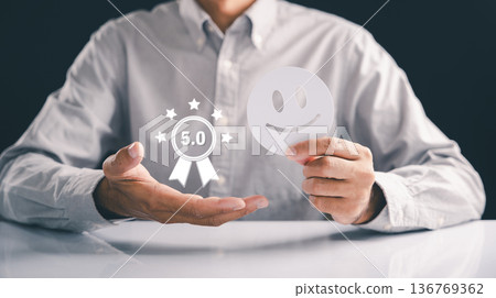 Happy customer service is assured as a person displays a five star graphic above an open hand and a smiling face, showing quality assurance to every client and ultimate satisfaction for the client Happy customer service is assured as a person displays a five star graphic above an open hand and a smiling face, showing quality assurance to every client and ultimate satisfaction for the client 136769362
