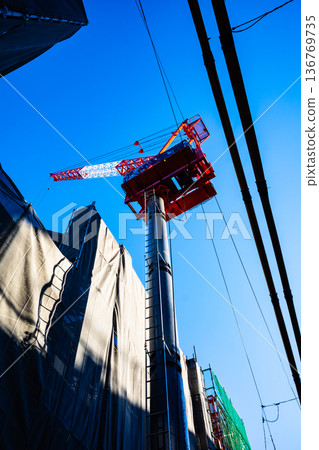 Apartment building construction in the city, tower cranes and power lines f-2 High saturation contrast Apartment building construction in the city, tower cranes and power lines f-2 High saturation contrast 136769735