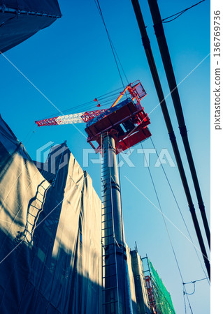 Apartment building construction in the city, tower cranes and power lines f-3 Warm and cool colors Apartment building construction in the city, tower cranes and power lines f-3 Warm and cool colors 136769736