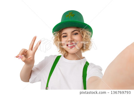 Woman in a green leprechaun hat makes a peace sign, isolated, PNG Woman in a green leprechaun hat makes a peace sign, isolated, PNG 136769793