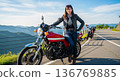 A young woman riding a motorcycle (vintage car) 136769885