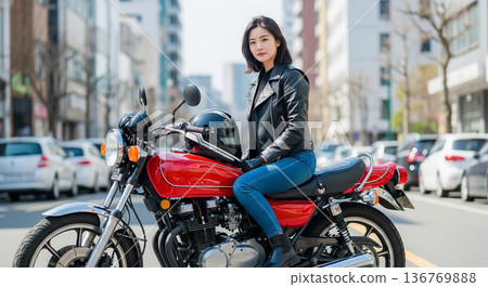 A young woman riding a motorcycle (vintage car) 136769888