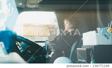 Truck driver taking a nap during waiting time 136771199