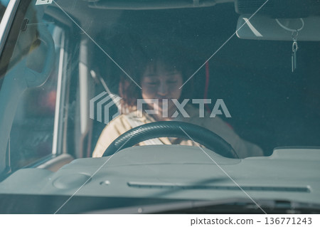 Woman sleeping in car Woman sleeping in car 136771243