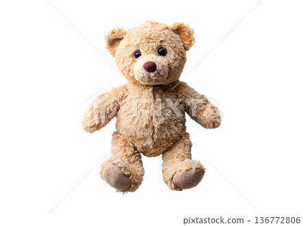Worn teddy bear with torn chest showing stuffing damage and wear 136772806