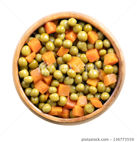 Canned green peas and diced carrots in wooden bowl. Carrots, Daucus carota, cut into block shape, mixtured with seeds of Pisum sativum, boiled and preserved. Closeup, isolated from above, food photo. Canned green peas and diced carrots in wooden bowl. Carrots, Daucus carota, cut into block shape, mixtured with seeds of Pisum sativum, boiled and preserved. Closeup, isolated from above, food photo. 136773559