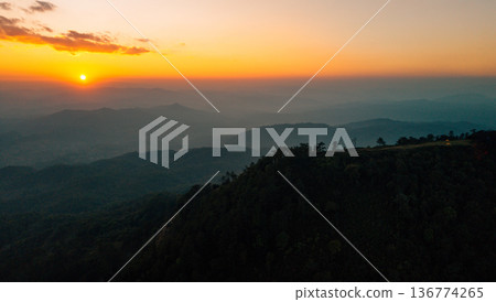 Breathtaking aerial landscape of layered mountains silhouette at golden hour sunset. Breathtaking aerial landscape of layered mountains silhouette at golden hour sunset. 136774265