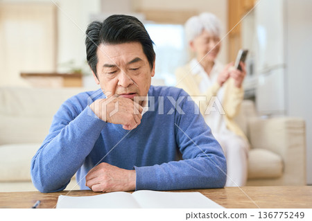 Worried Asian senior man and his carefree wife 136775249