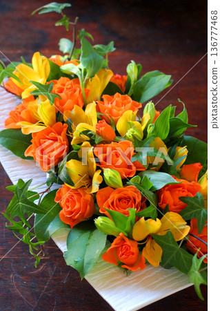 Wedding table flowers with orange roses 136777468