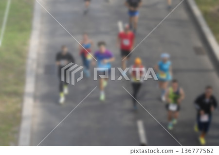 A blurry image of a group of people running on a road A blurry image of a group of people running on a road 136777562