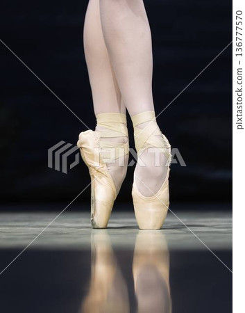Close-up of ballet dancers legs in pointe shoes Close-up of ballet dancers legs in pointe shoes 136777570