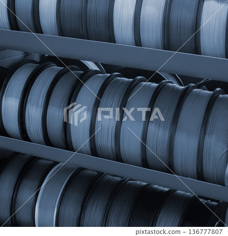 Spool of plastic wire for 3D printing. Different spool with plastic close-up. Component for 3d printing. Printing accessories. Concept 3D printing technology. Additive progressive FDM technologies Spool of plastic wire for 3D printing. Different spool with plastic close-up. Component for 3d printing. Printing accessories. Concept 3D printing technology. Additive progressive FDM technologies 136777807