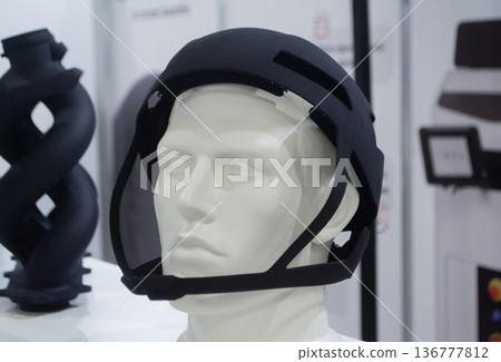 Protective helmet. Helmet printed on 3D printer from powder material. Model printed on 3D printer from melted polyamide powder. Multi Jet Fusion. Modern additive progressive 3D printing technology Protective helmet. Helmet printed on 3D printer from powder material. Model printed on 3D printer from melted polyamide powder. Multi Jet Fusion. Modern additive progressive 3D printing technology 136777812