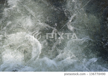 Water splashing on stones Water splashing on stones 136778490