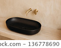 Elegant matte black oval basin with gold faucet on wooden vanity 136778690