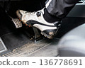 Male cyclist's foot on car pedal in dirty cycling shoe close-up 136778691