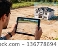 Caucasian male using tablet for ar home visualization on construction site 136778694