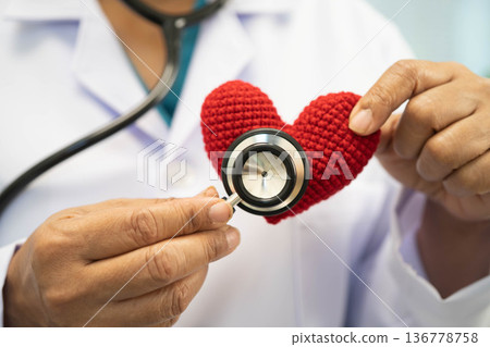 Asian woman doctor holding red heart for health in hospital. 136778758