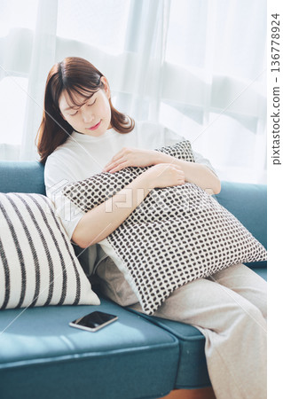 Tired woman relaxing at home Tired woman relaxing at home 136778924
