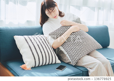 Tired woman relaxing at home Tired woman relaxing at home 136778925
