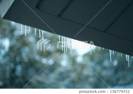 Icicles on the window 136779352