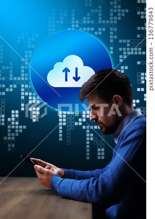 Man using smartphone for cloud transfer in a digital workspace environment Man using smartphone for cloud transfer in a digital workspace environment 136779843
