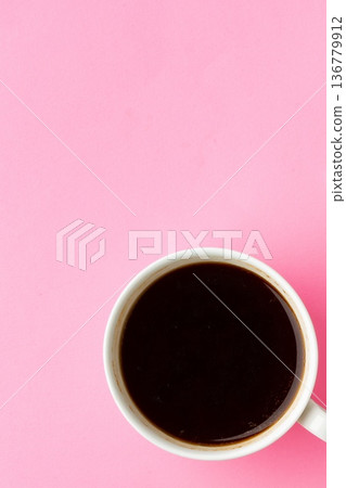 Black coffee in a white cup on a pink background during daylight hours 136779912