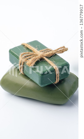 Green soap bars wrapped with twine on a white background with simple design Green soap bars wrapped with twine on a white background with simple design 136779917