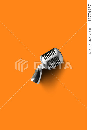 Podcast microphone on orange background ready for recording conversations and discussions Podcast microphone on orange background ready for recording conversations and discussions 136779927