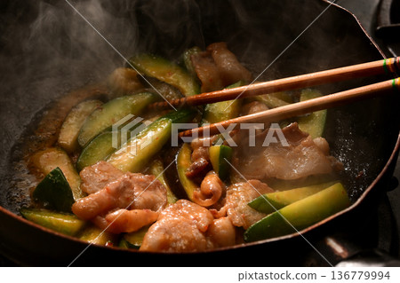 Cooking scene of stir-fried eggplant, cucumber, and pork with spicy miso 136779994