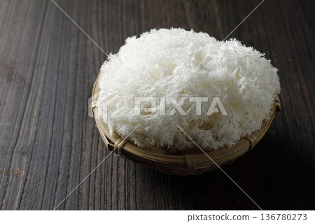 Yamabushi mushrooms in a colander on a wood grain background Yamabushi mushrooms in a colander on a wood grain background 136780273