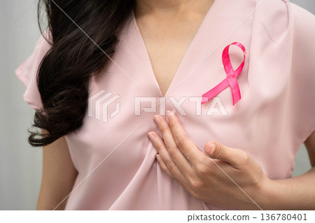 Asian woman with pink ribbon, World Breast Cancer Day at October. Asian woman with pink ribbon, World Breast Cancer Day at October. 136780401