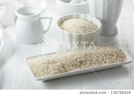 Raw organic rice in white dish. 136780426