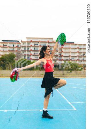 Cheerleader Girl Cheers Her Team On The Basketball Court 136780800