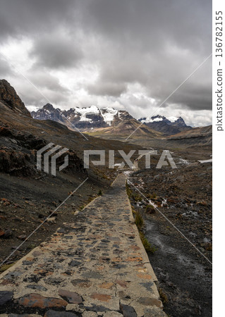 Stone trail leading to Pastoruri Glacier, Huaraz, Peru, amidst rugged mountains Stone trail leading to Pastoruri Glacier, Huaraz, Peru, amidst rugged mountains 136782155