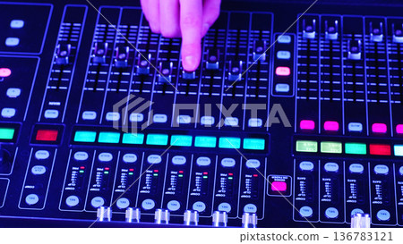 Sound Engineer, Audio Technician Adjusting Faders, Managing Digital Mixing Console From Above, Professional Music Production Concept Sound Engineer, Audio Technician Adjusting Faders, Managing Digital Mixing Console From Above, Professional Music Production Concept 136783121