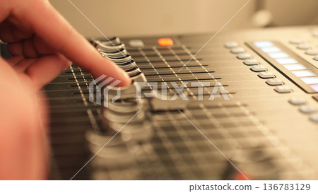 Hand Sound Engineer and Audio Mixer, Adjusting Fader, Controlling Levels. Music Production, Sound Engineering, Studio Recording. 136783129