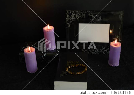 funeral, a photo frame, candles, marble urn for ashes, holy bible and spiritual bracelet with black cross 136783136