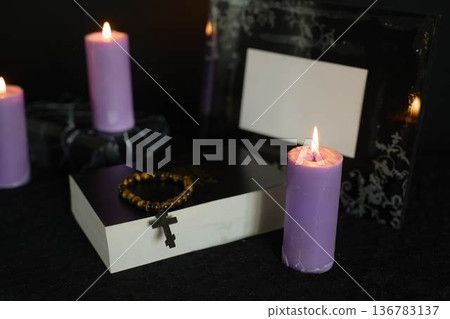 funeral, a photo frame, candles, marble urn for ashes, holy bible and spiritual bracelet with black cross 136783137