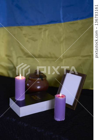 funeral of Ukrainian , photo frame, candles, marble urn for ashes, holy bible and acspiritual bracelet with black cross 136783161
