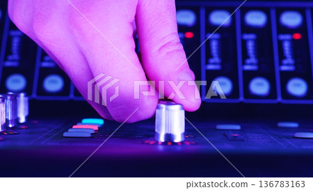 Audio Technician, Sound Engineer Adjusting Control Knob, Managing Sound Levels On Digital Mixing Console, Professional Audio Technology Concept 136783163