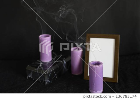 funeral, a photo frame, marble urn for ashes and smoke from extinguished candles, farewell funeral, a photo frame, marble urn for ashes and smoke from extinguished candles, farewell 136783174