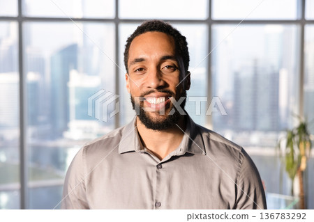 Happy handsome African American business leader man posing in office 136783292