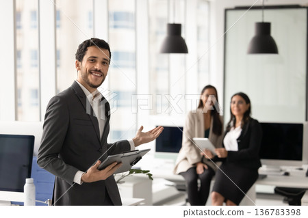 Man presenting two women, staff members, colleagues to client Man presenting two women, staff members, colleagues to client 136783398