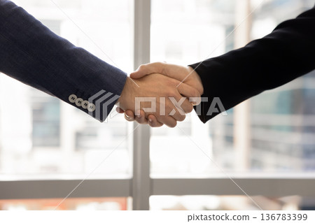 Close up image, handshake between two businessmen Close up image, handshake between two businessmen 136783399