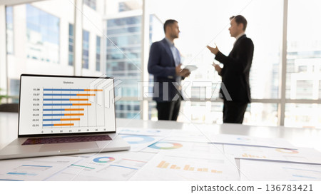 Closeup focus on laptop displaying statistics data in bar graphs Closeup focus on laptop displaying statistics data in bar graphs 136783421