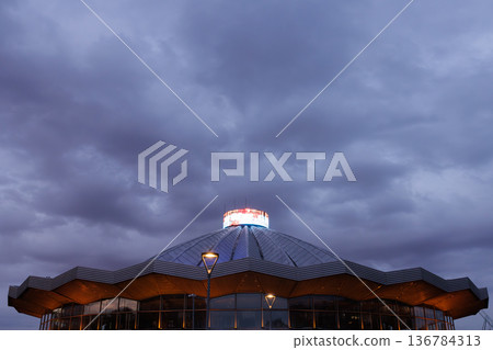 Striking architectural beauty stands under moody clouds at twilight in a vibrant city Striking architectural beauty stands under moody clouds at twilight in a vibrant city 136784313