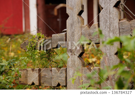 Wooden fence detail showcasing rustic charm in a serene countryside setting during autumn afternoon 136784327