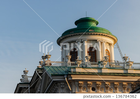 Historic building with green dome under clear blue sky during early morning light in a city setting Historic building with green dome under clear blue sky during early morning light in a city setting 136784362