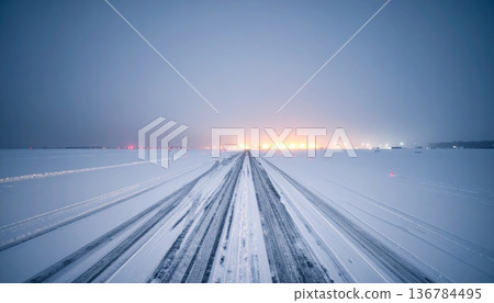 A fast car driving on a winter night blurrs past the empty asphalt of a Chicago highway transportation landscape under a dark sky A fast car driving on a winter night blurrs past the empty asphalt of a Chicago highway transportation landscape under a dark sky 136784495
